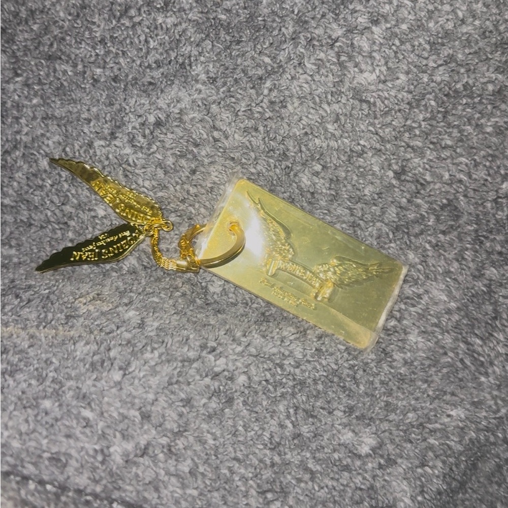 Robin jean gold keychain, like new, still in its packaging